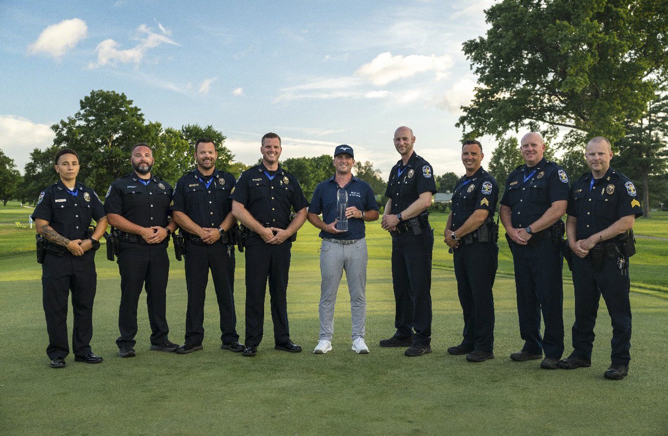 The 2026 ISCO Championship security detail with the champion and trophy on the course at Hurstbourne Country Club